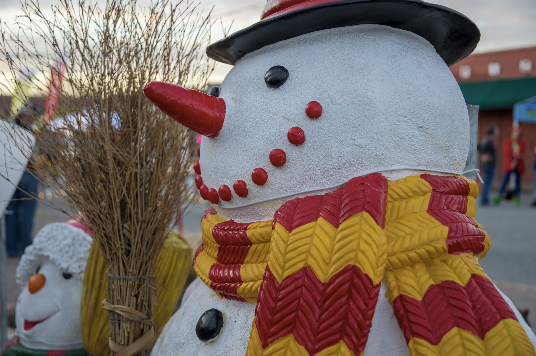 Snowman decoration wearing a top hat and scarf.