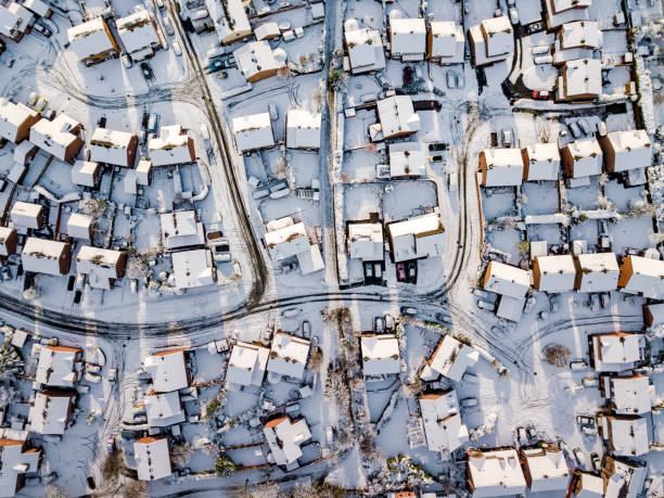 An aerial view of a residential neighborhood covered in snow.